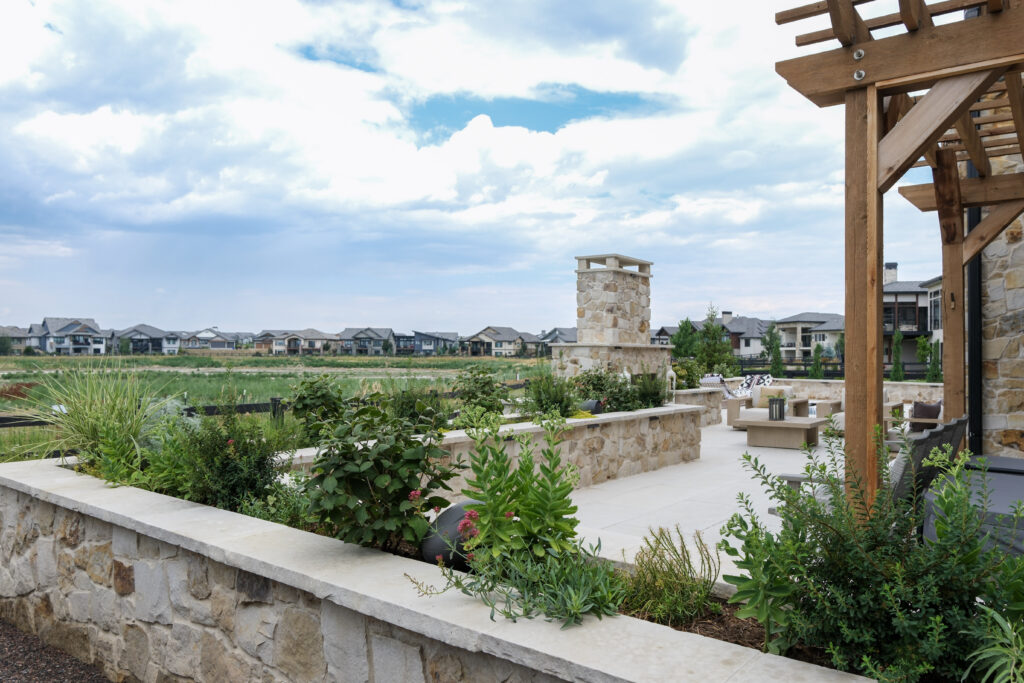 custom patio with stone seatwalls, pergola, fireplace and plunge pool in Fort Collins Colorado by Summit Outdoor Living