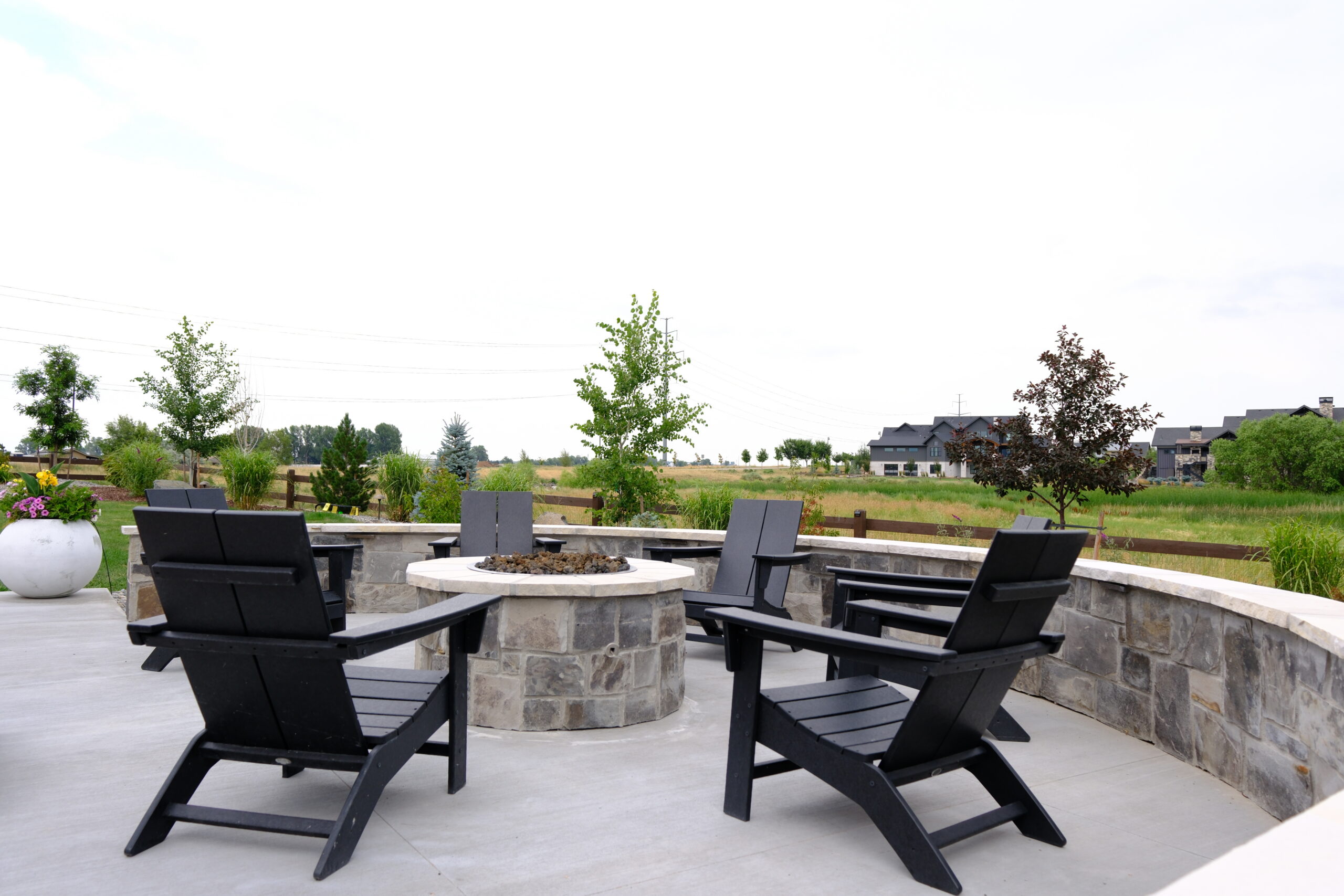 custom patio with fire pit and seat wall in Fort Collins Colorado by Summit Outdoor Living